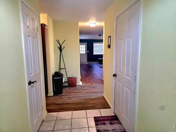 a view of a hallway with wooden floor and stairs