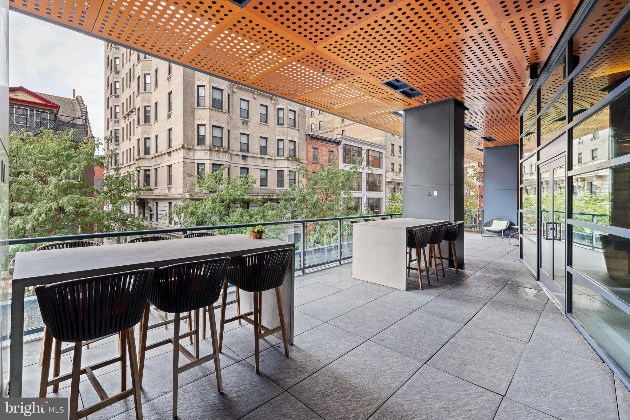 1213 Walnut Street, Unit 1706 Philadelphia, PA 19107 - Photo 15 of 36 a view of a chairs and table in a patio
