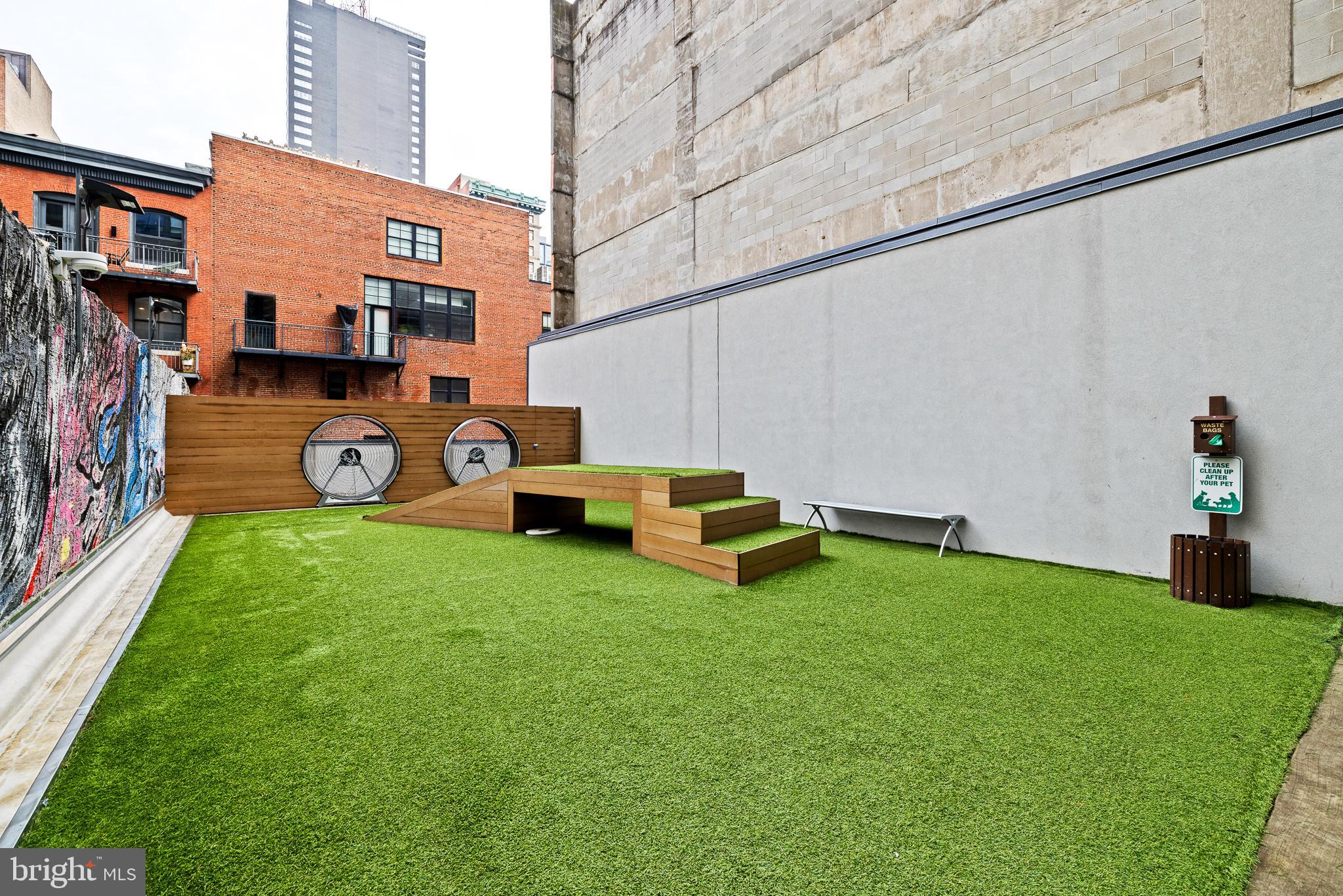 1213 Walnut Street, Unit 1706 Philadelphia, PA 19107 - Photo 22 of 36 a view of a backyard with table and chairs and a barbeque