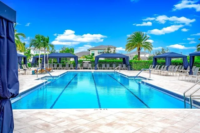 a view of a swimming pool with an outdoor seating
