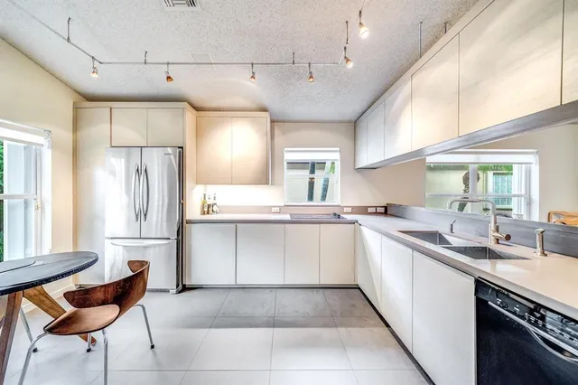 a kitchen with a sink cabinets and window