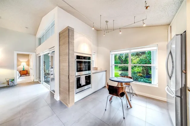 a view of kitchen with furniture and large windows