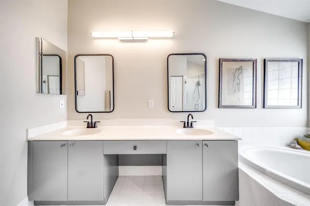 a bathroom with double vanity sinks and a mirror
