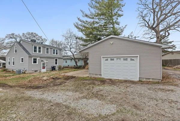 a house that has a large tree in front of it