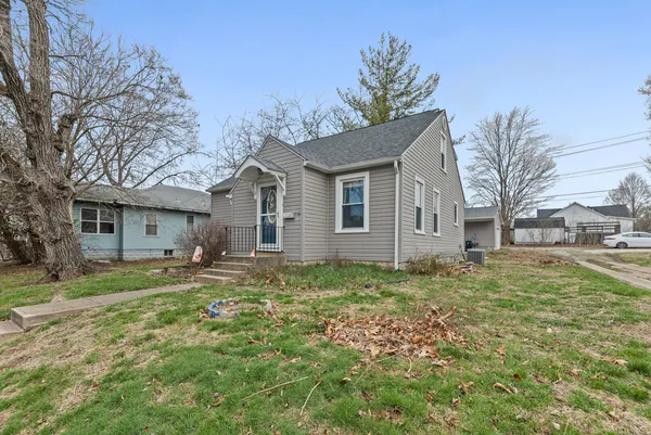 a view of a yard with a house and a tree