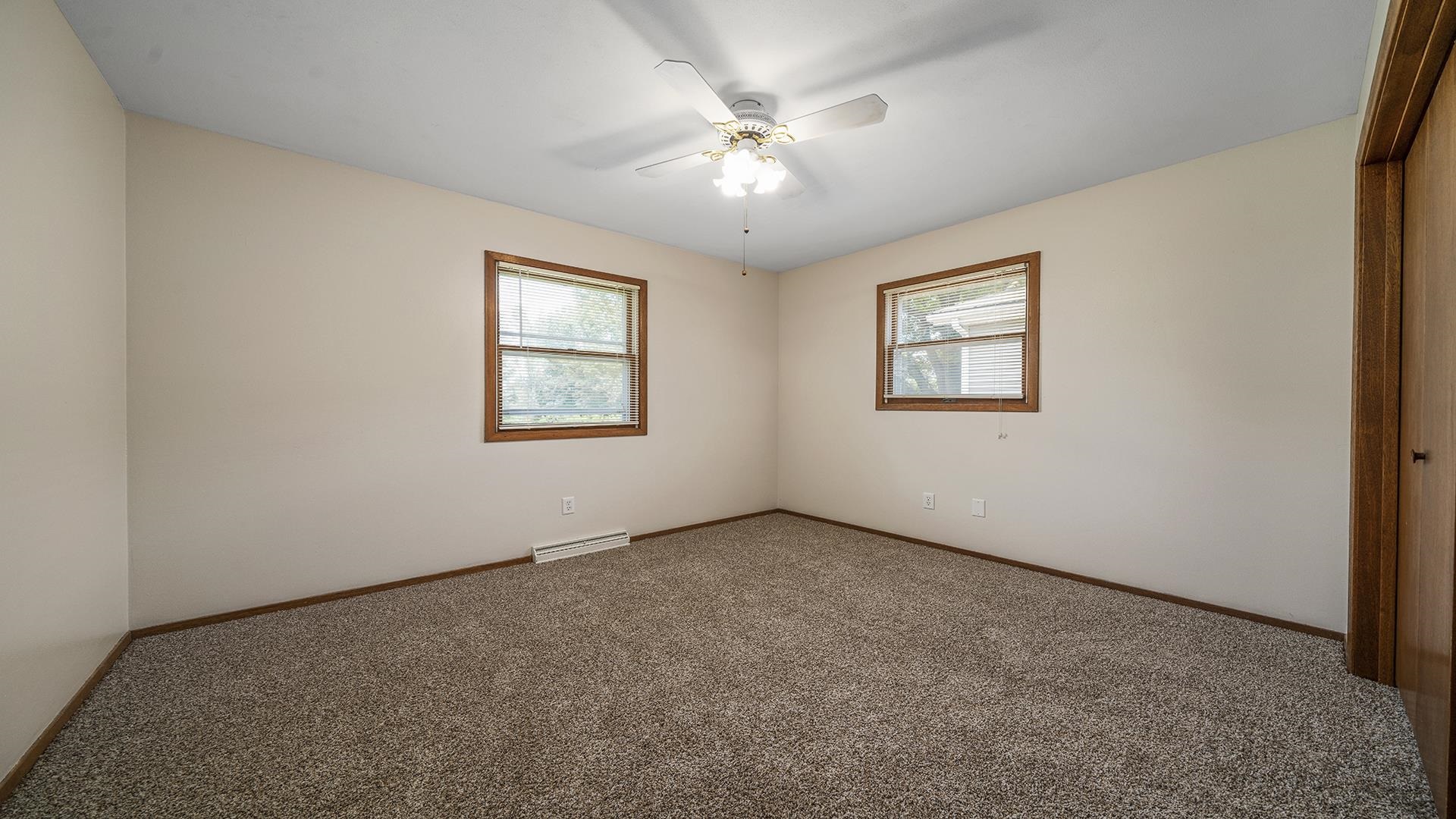 503 Sunset Drive Polo, IL 61064 - Photo 13 of 34 an empty room with windows and fan