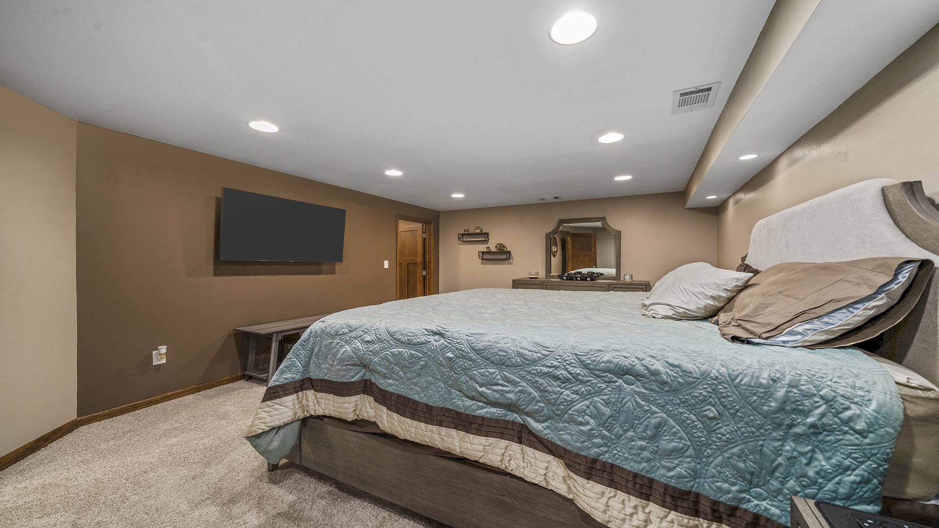 503 Sunset Drive Polo, IL 61064 - Photo 18 of 34 a spacious bedroom with a bed and a flat screen tv