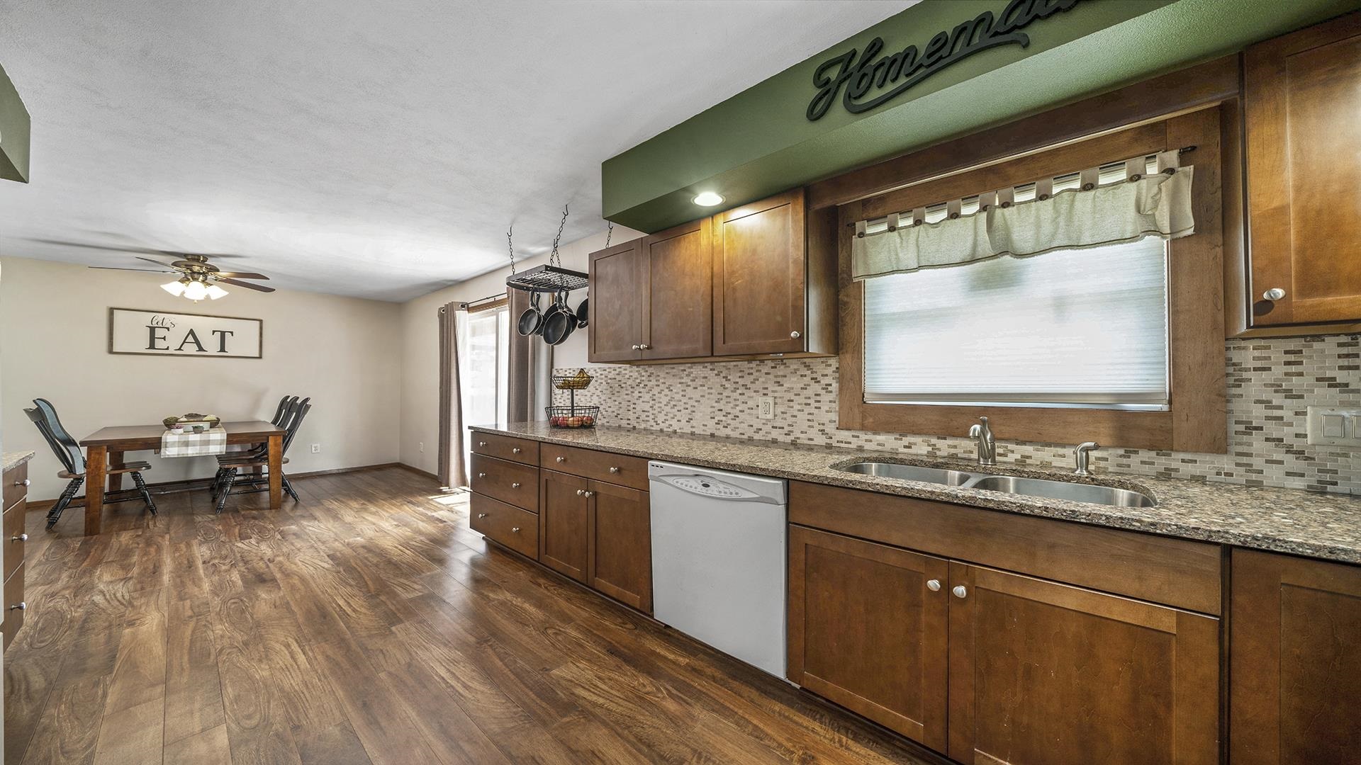 503 Sunset Drive Polo, IL 61064 - Photo 5 of 34 a kitchen with stainless steel appliances granite countertop sink stove and wooden cabinets