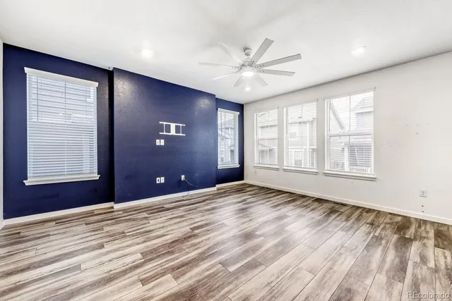 a view of an empty room with a window and closet area