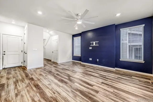 a view of an empty room with a ceiling fan