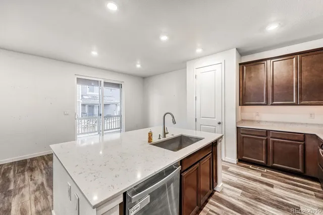 a kitchen with stainless steel appliances granite countertop a sink stove and cabinets