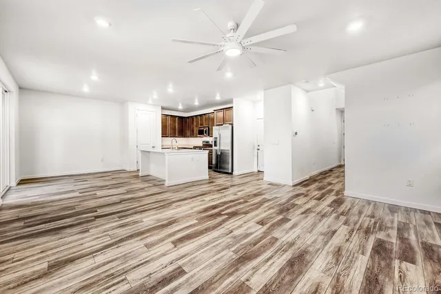 a view of a kitchen with a sink and a refrigerator