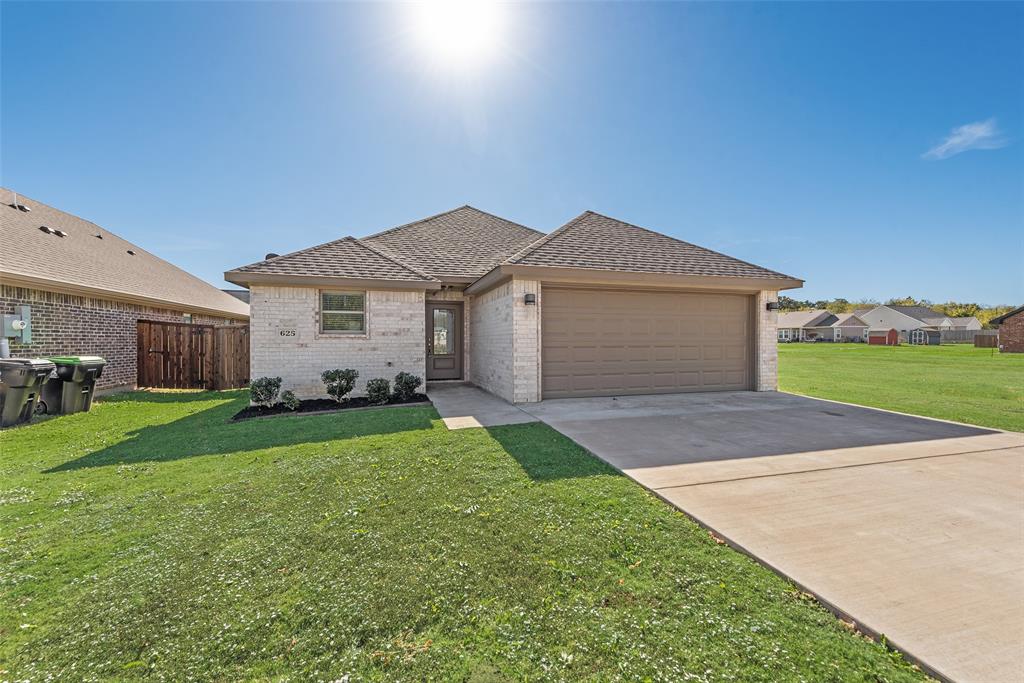 625 Copenhavr Street Pilot Point, TX 76258 - Photo 3 of 20 a front view of a house with a garden and yard