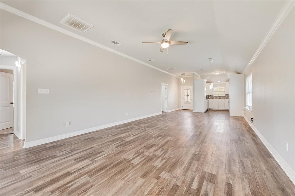 625 Copenhavr Street Pilot Point, TX 76258 - Photo 8 of 20 wooden floor in an empty room with a window