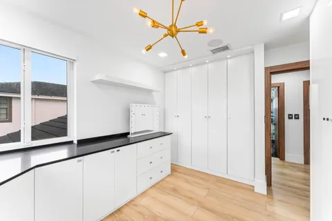 a kitchen with granite countertop a sink and cabinets