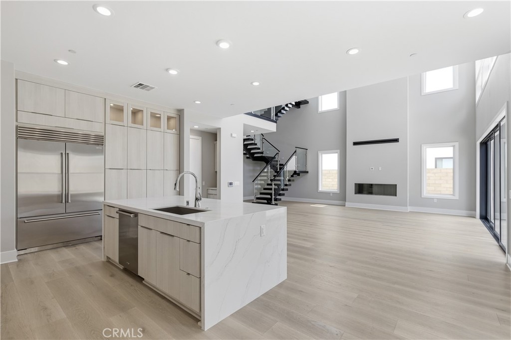 156 Apron Irvine, CA 92618 - Photo 8 of 40 a kitchen with stainless steel appliances granite countertop a sink and a refrigerator