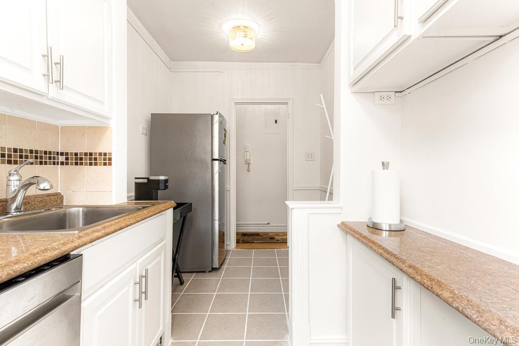 100-10 67th Road, Unit 6L Queens, NY 11375 - Photo 9 of 26 a kitchen with a sink and refrigerator