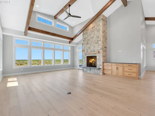 a view of an empty room with a fireplace and a window