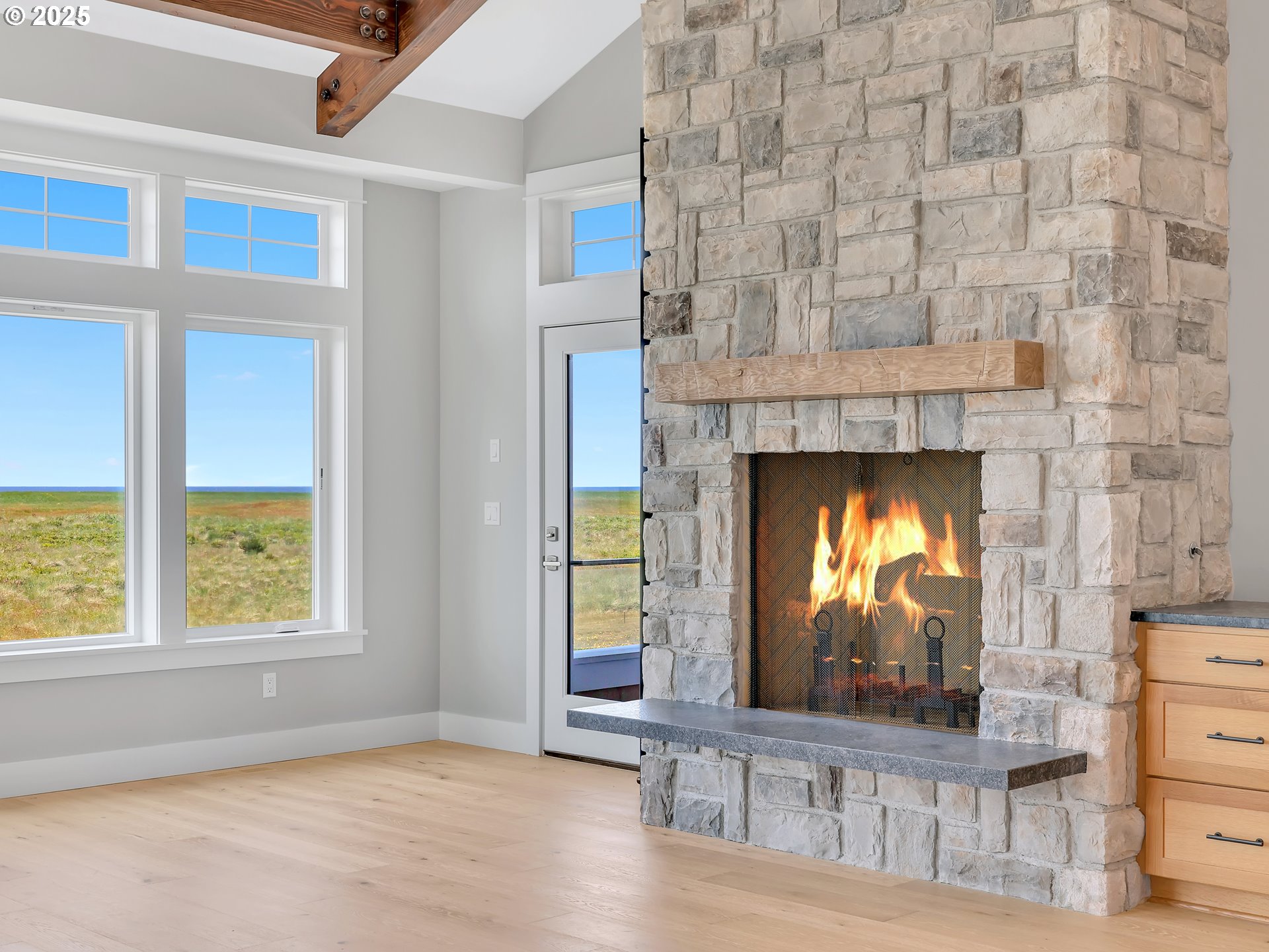 1400 North Ocean Avenue Gearhart, OR 97138 - Photo 13 of 35 a living room with a fireplace windows and a wooden floor