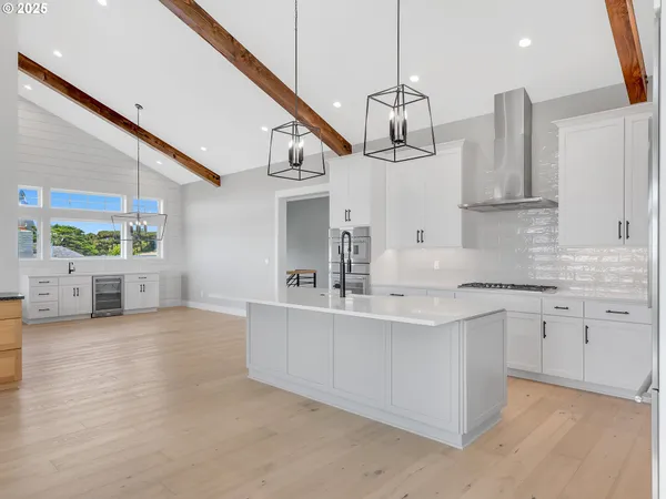 a kitchen with stainless steel appliances kitchen island granite countertop a sink and cabinets