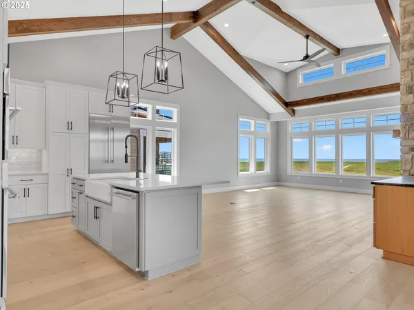 a kitchen with stainless steel appliances granite countertop a stove and cabinets with wooden floor