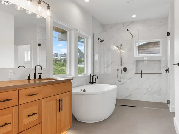 a bathroom with a tub sink and mirror