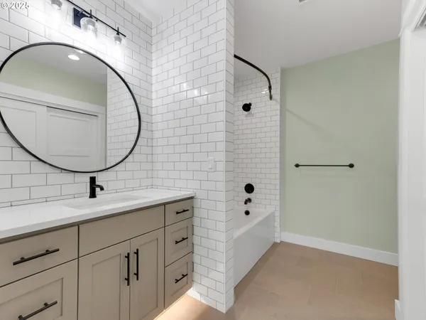 a kitchen with white cabinets and sink