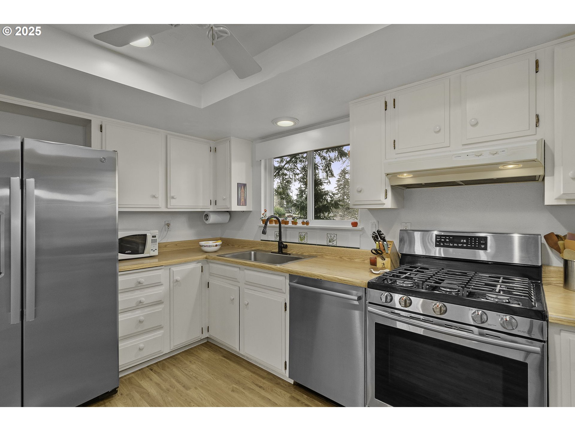 303 Cherry Avenue Oregon City, OR 97045 - Photo 6 of 30 a kitchen with cabinets stainless steel appliances and a sink