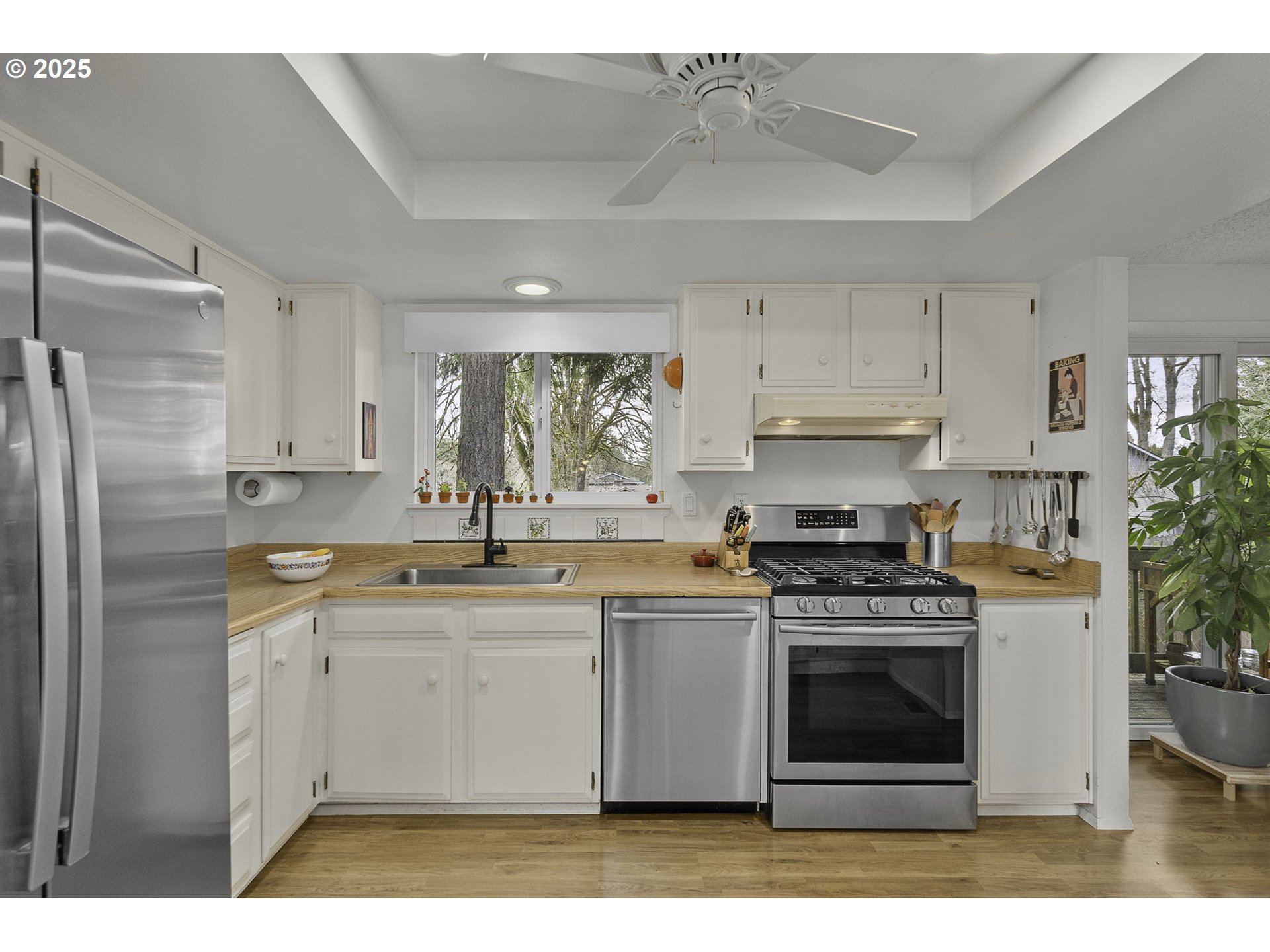 303 Cherry Avenue Oregon City, OR 97045 - Photo 7 of 30 a kitchen with stainless steel appliances granite countertop a stove a sink and a refrigerator