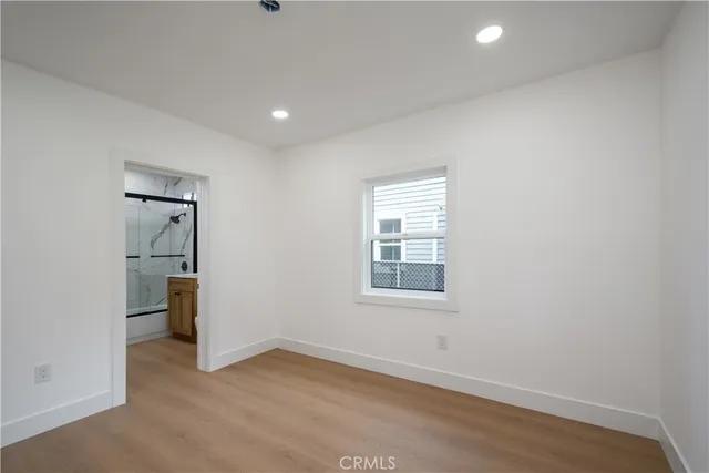 an empty room with a gallery and wooden floor