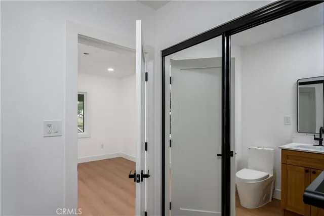 a bathroom with a granite countertop toilet and a sink