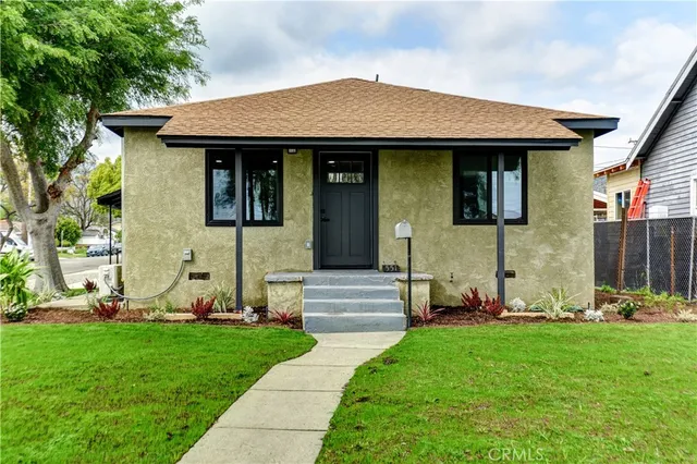 a front view of a house with a garden