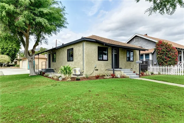 a front view of house with yard and green space
