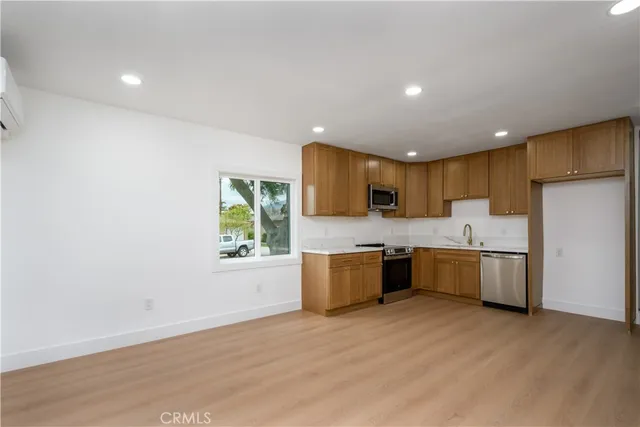 a large kitchen with a lot of counter space and stainless steel appliances