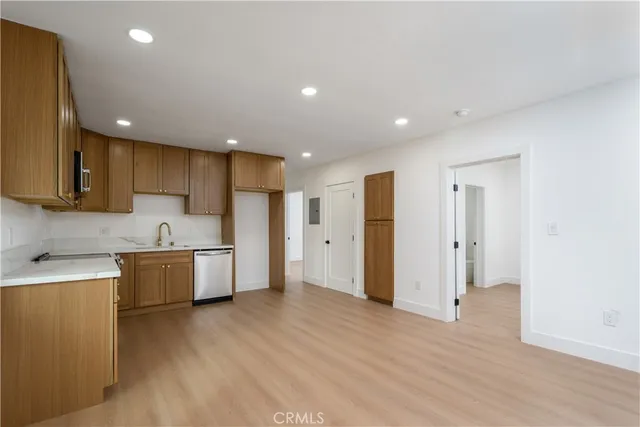 a large kitchen with a lot of counter space and stainless steel appliances