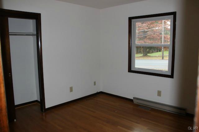 8515 Rextown Road Slatington, PA 18080 - Photo 8 of 14 a view of an empty room with wooden floor and a window