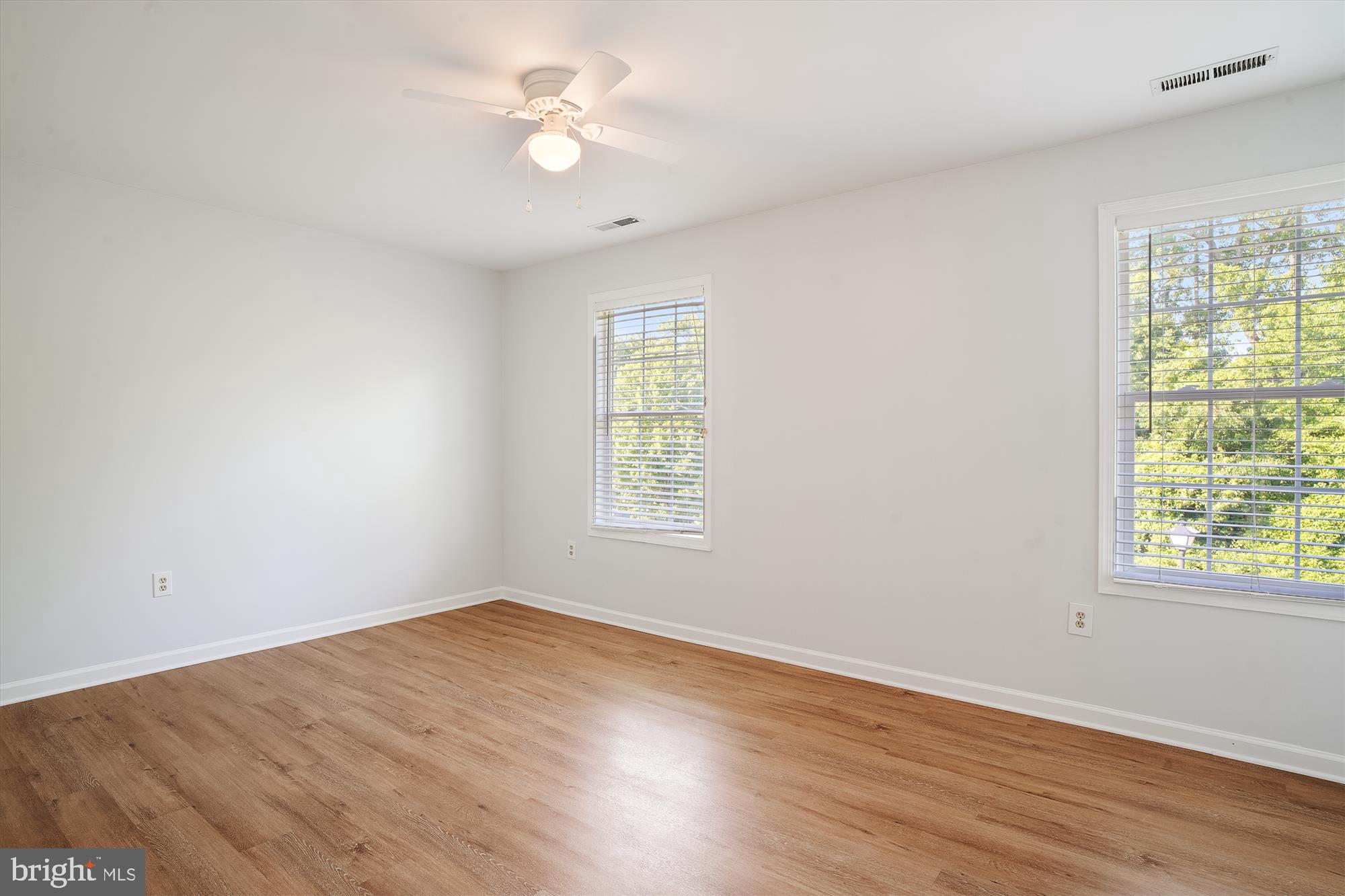8186 June Way, Unit 203 Easton, MD 21601 - Photo 13 of 22 wooden floor in an empty room with a window