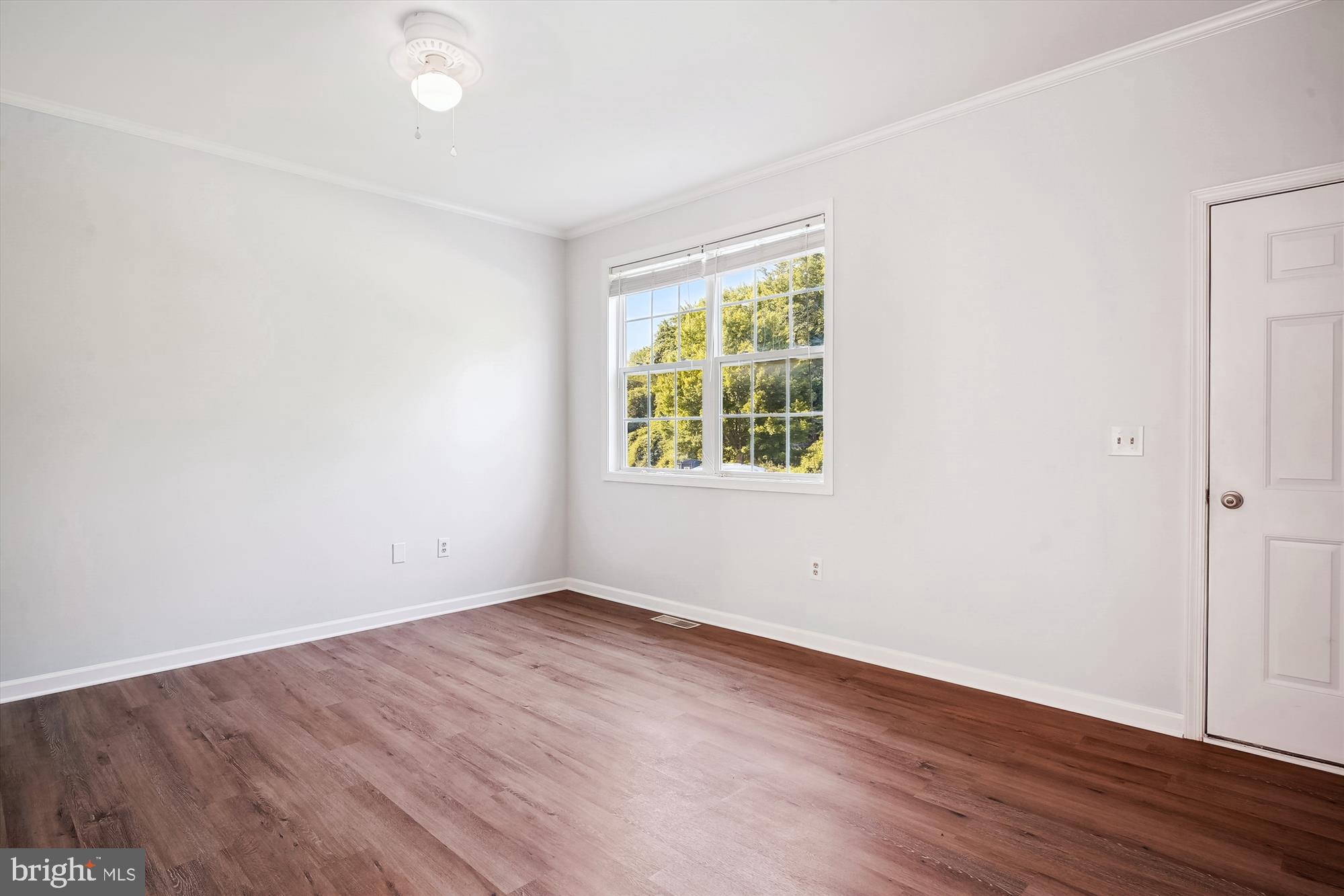 8186 June Way, Unit 203 Easton, MD 21601 - Photo 8 of 22 an empty room with wooden floor and windows