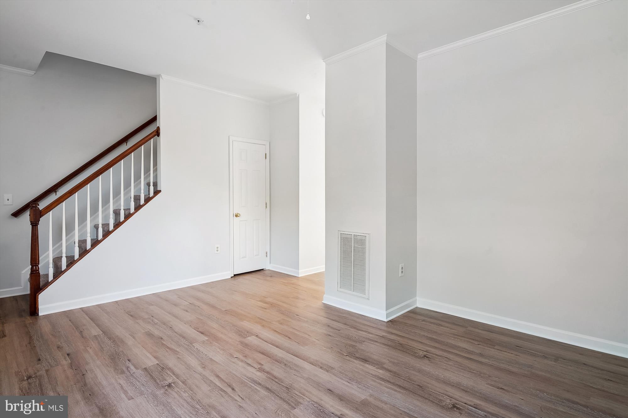 8186 June Way, Unit 203 Easton, MD 21601 - Photo 10 of 22 a view of an empty room with wooden floor