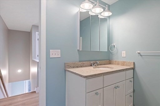 74 Hill Road, Unit A Charlton, MA 01507 - Photo 20 of 24 a bathroom with a sink vanity and a mirror