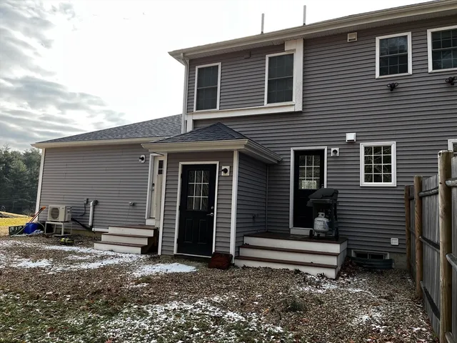 a backyard of a house with barbeque oven table and chairs