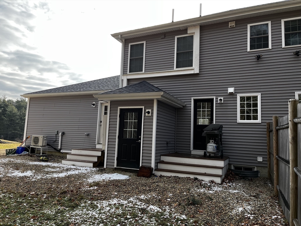 74 Hill Road, Unit A Charlton, MA 01507 - Photo 2 of 24 a backyard of a house with barbeque oven table and chairs