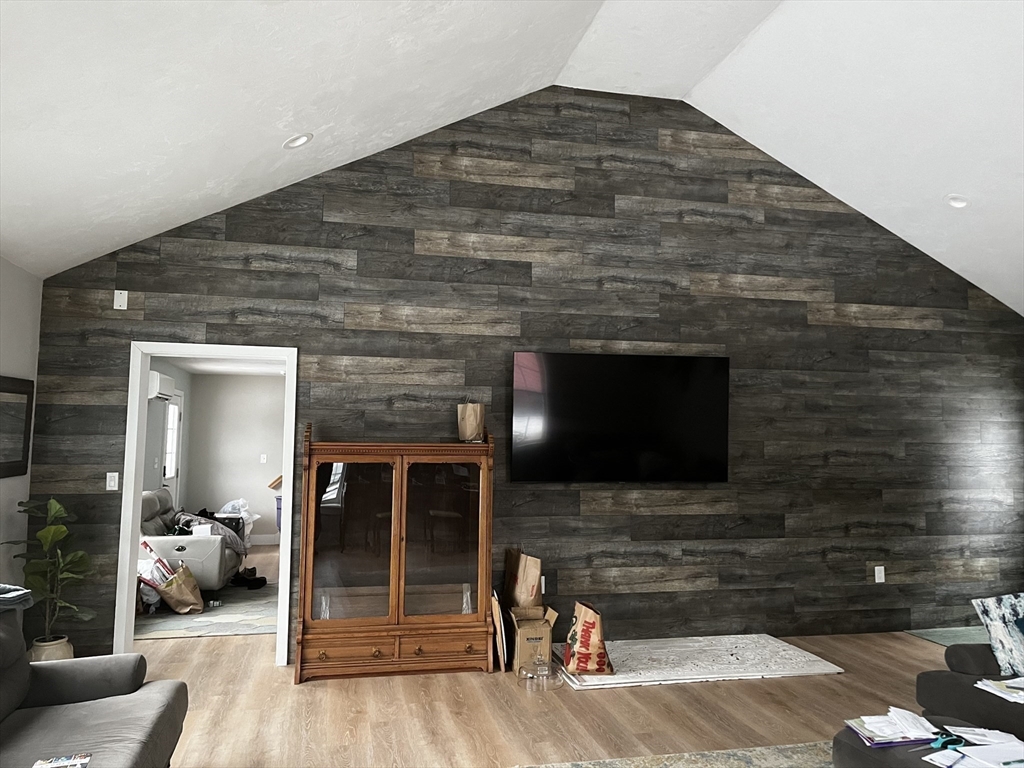 74 Hill Road, Unit A Charlton, MA 01507 - Photo 24 of 24 a living room with a flat screen tv and a fireplace