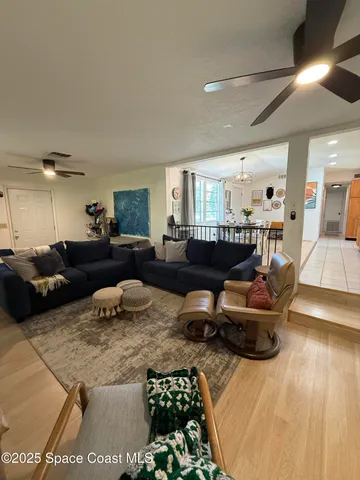 a spacious bedroom with a bed a dresser and a book shelf