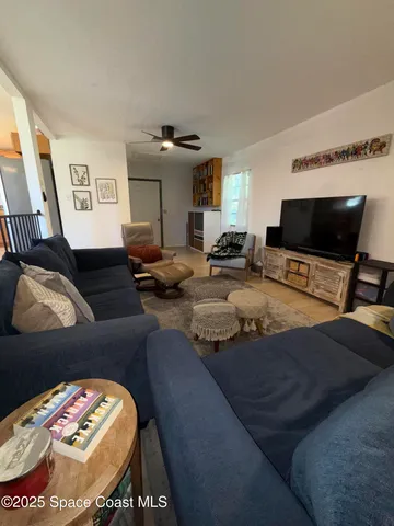 a living room with furniture a rug and a projector