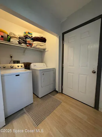 a utility room with dryer washer and other items