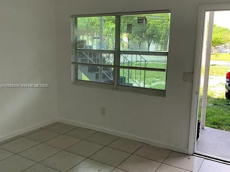 1277 Northwest 58th Street Miami, FL 33142 - Photo 4 of 9 a view of a room that has a window in it