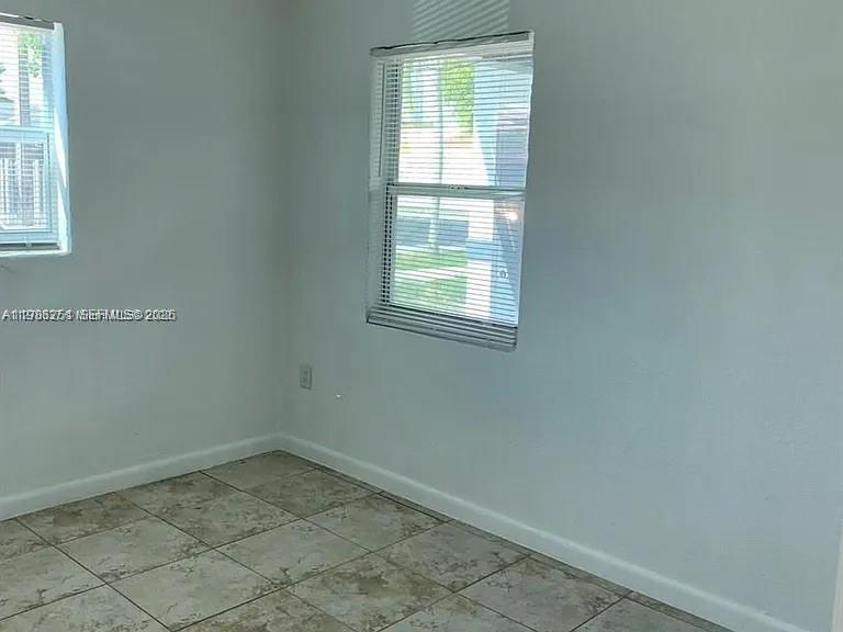 1277 Northwest 58th Street Miami, FL 33142 - Photo 9 of 9 an empty room with a window
