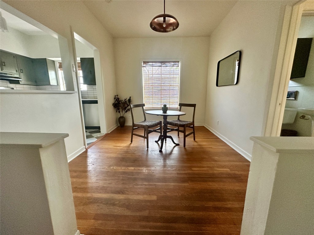 1700 Houston Street, Unit 201 Austin, TX 78756 - Photo 13 of 26 a view of a livingroom with furniture a fireplace wooden floor and windows