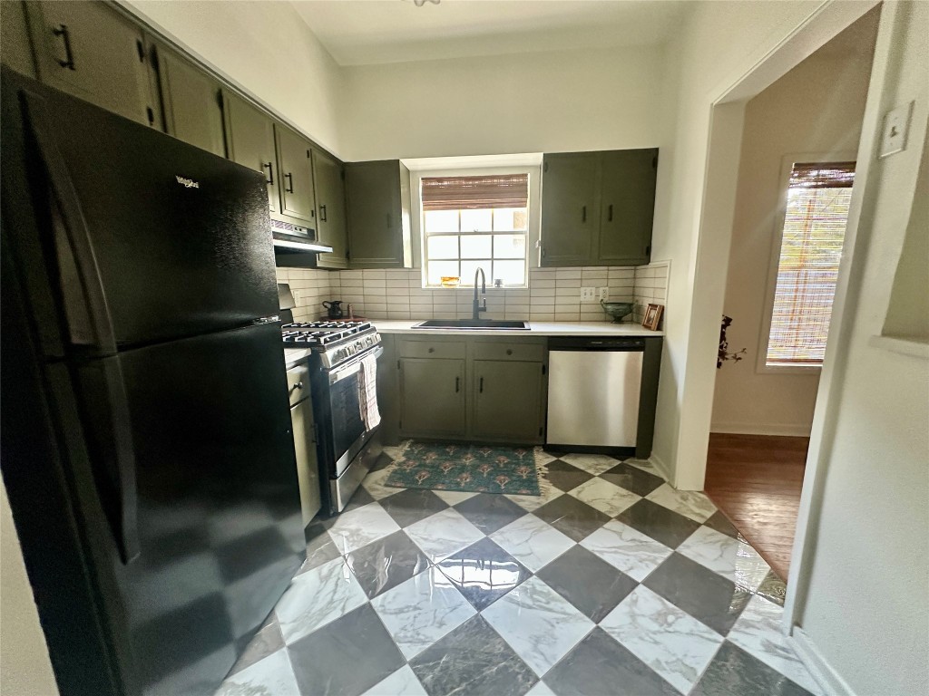 1700 Houston Street, Unit 201 Austin, TX 78756 - Photo 17 of 26 a kitchen with stainless steel appliances granite countertop a refrigerator and a sink